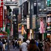 Passersby walk on the street at Shibuya shopping and amusement district, Tokyo, Japan, 28 July 2022 (Photo: Reuters/Issei Kato).